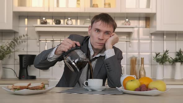 Tired Man Pouring Coffee Early in the Morning