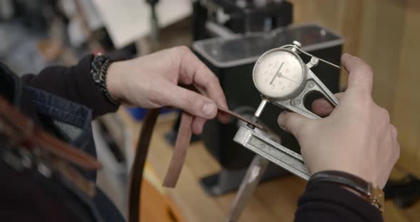 Craftsman Working with Leather in a Workshop