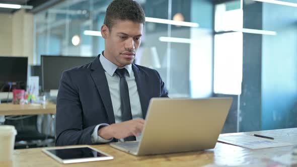 Hardworking African Businessman Having Headache in Office