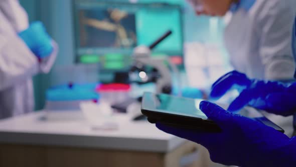 Close Up Scientist Writing Tablet