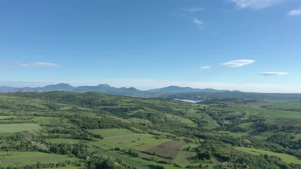 Blue sky by early morning over the valley of mountains in Eastern Serbia 4K aerial video