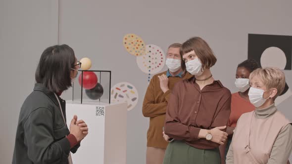 People in Face Masks at Exhibition in Modern Art Museum