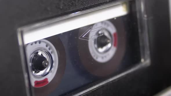 Audio Cassette Is Inserted Into the Deck of the Audio Tape Recorder Playing and Rotates