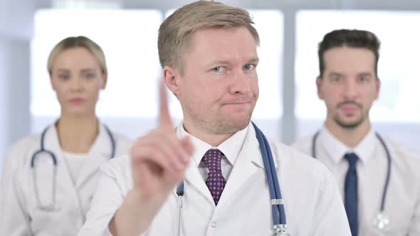 Portrait of Serious Doctors Saying No By Hand Gesture