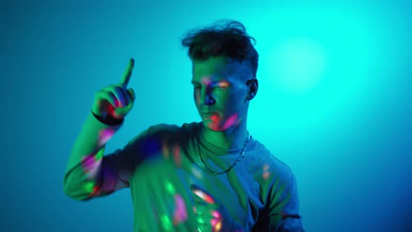 Portrait Funny Stylish Man Looking at Camera Dancing in Colorful Neon Lighting
