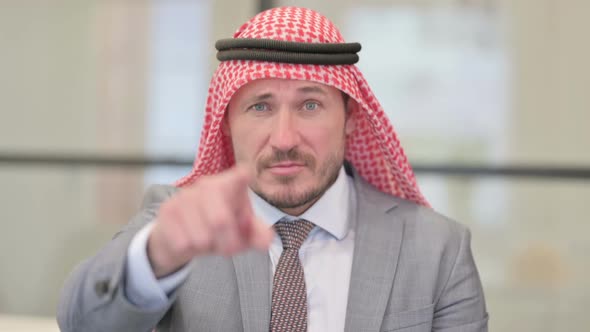 Portrait of Middle Aged Arab Businessman Pointing at the Camera