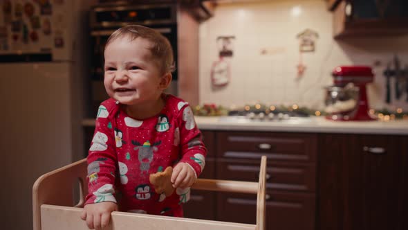 Baby Boy in Pajamas in Christmas Kitchen