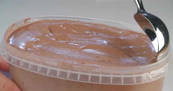 Chocolate ice cream with ice cream scoop in slow motion