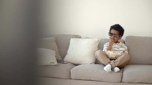 African American Little Boy Watching 3d Movie on Couch