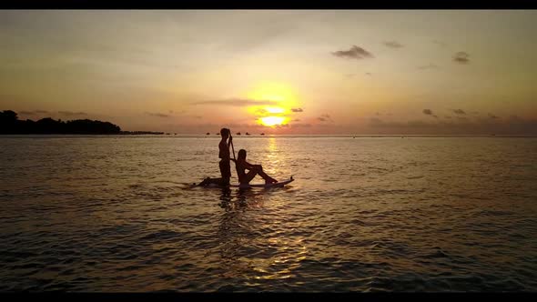 Romantic couple sunbathe on paradise resort beach time by blue lagoon with white sand background of 