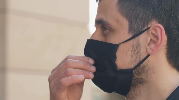 Coronavirus Is Defeated. Man Takes Off a Protective Mask.