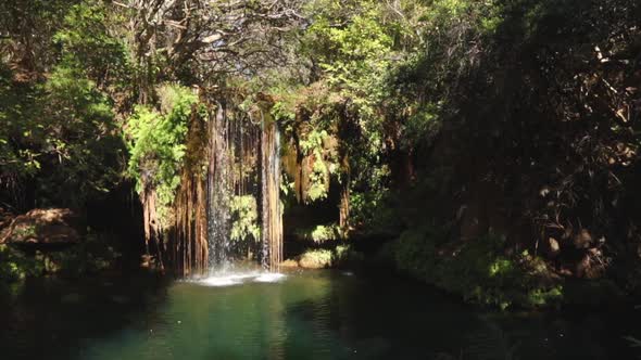 Footage of a small waterfall with a clear blue plunge pool in the Blyde River canyon Gorge on the Pa