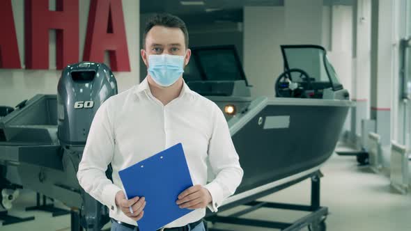 Salesman in the Motorboat Shop Is Wearing a Face Mask