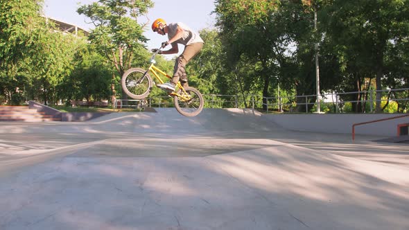 BMX Rider Doing Tricks in Cocncrete Skatepark Slow Motion