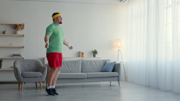 Overweight Man Jumping with Skipping Rope but Feeling Irritated Throw It Down and Lying on Coach