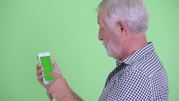 Closeup Rear View of Senior Bearded Man Using Phone