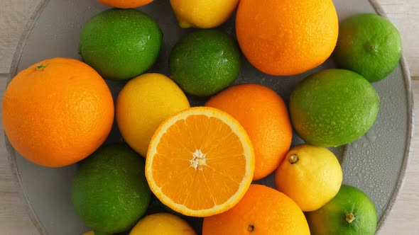 Half Cut Juicy Orange on Citrus Fruit Background, a Lot of Lemon, Oranges and Limes Top View