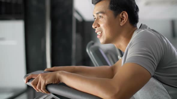 Asian Man Running on Treadmill