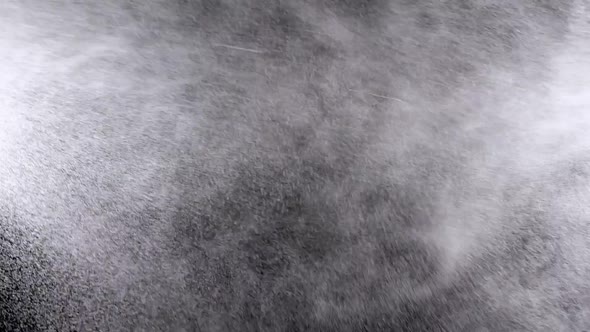 Water Spray on Black Background. Micro Drops of Water Fly in the Air. Slow Motion alt