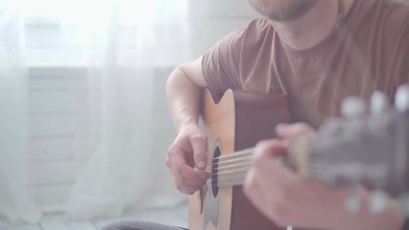 A Man Playing the Guitar