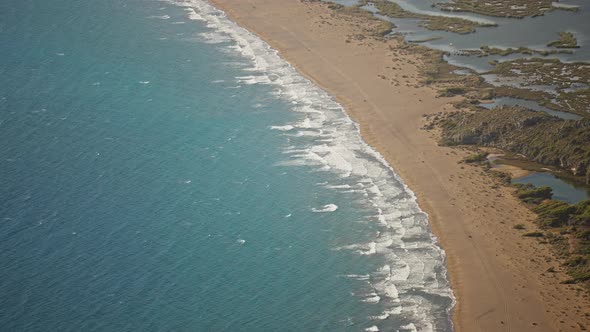 Aerial Slow Motion Waving Sea with Waves at Sunny Summer Windy Day at Beautiful Sandy Empty Beach