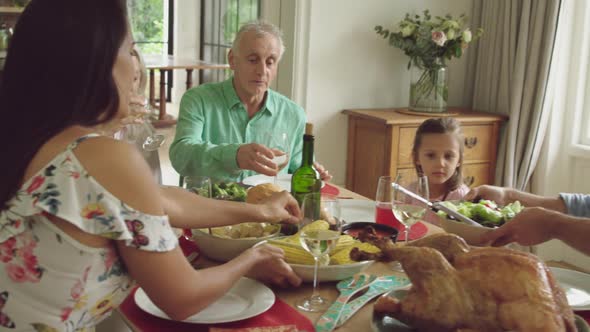 Three generation family eating together