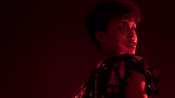 Woman in Sparkly Dress in Red Light in Nightclub