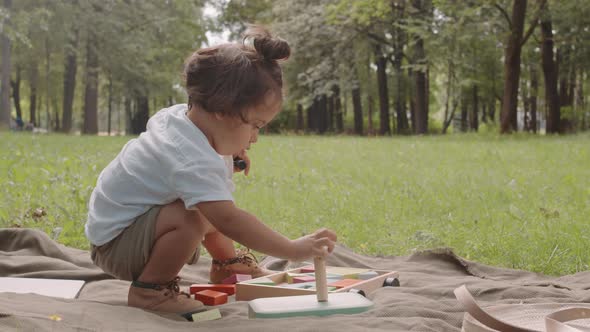 Toddler Boy Playing Puzzles Outdoors