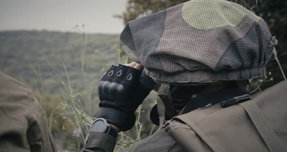 Israeli soldiers in a surveillance and reconnaissance mission using binoculars