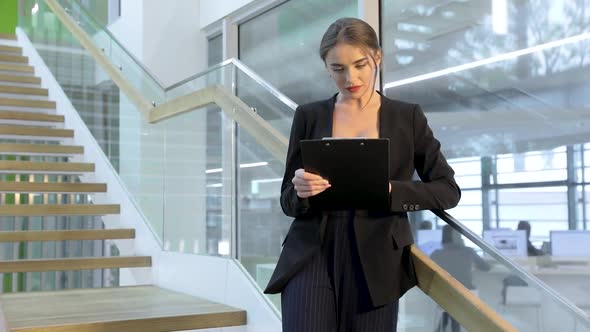 Business Woman With Folder In Hands In Office Building