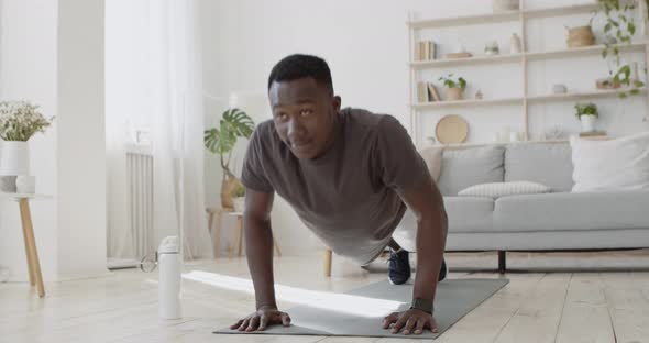 Young Sporty Black Man Doing Push Ups, Exercising on Floor