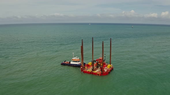 The Boat is Moored Near a Small Offshore Platform Not Far From the Shore