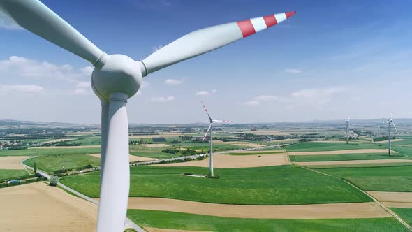 Aerial Flight Near Wind Turbines Energy Production. Clear Renewable Energy Concept