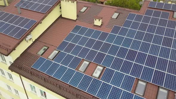 Aerial view of solar power plant with blue photovoltaic panels mounted of apartment building roof