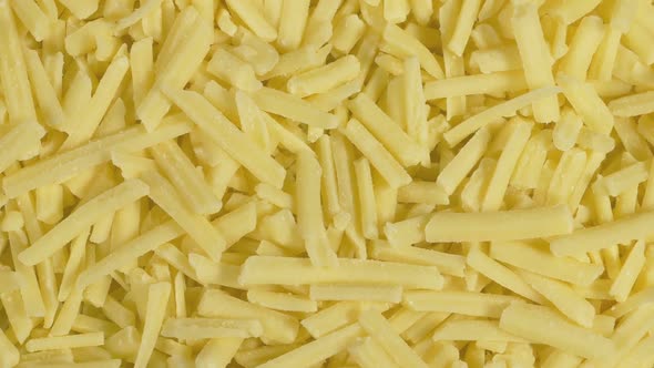 Extreme Closeup Of Grated Cheddar Cheese On Plate