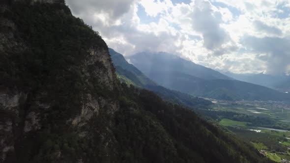 Aerial view of the mountains and forest in Borgo Valsugana in Trentino Italy with drone flying sidew