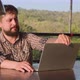 Handsome Bearded Man  Opening Laptop and Starting Work Outdoor - VideoHive Item for Sale