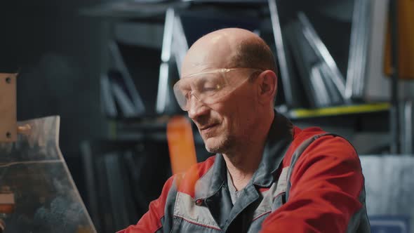 Professional Engineer at Work. Caucasian Man in Goggles and Uniform. Craftsman, Welder. Sparks Fly