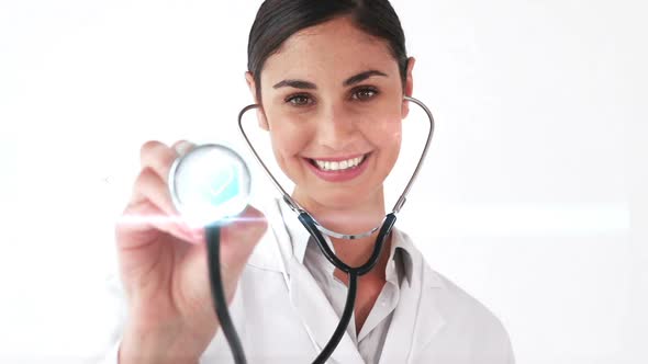 Smiling doctor holding stethoscope that shows various icons