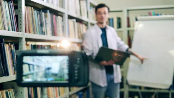 Library Man Holding Video Lesson It