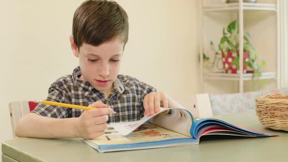 young boy preparing homework at home