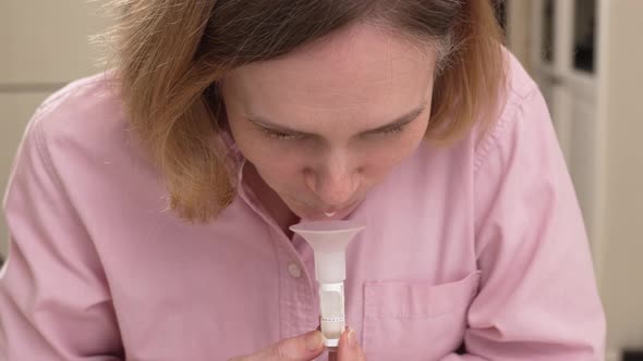 a Woman Collects Saliva in a Container for a Dna Test