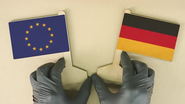 Flags of the European Union and Germany Made of Recycled Paper on the Cardboard Table Topdown View