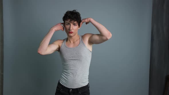 Portrait of a Transgender with Makeup Posing on Grey Background