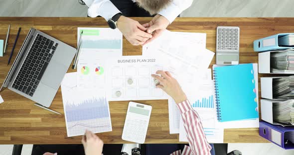 Group of Business People Putting Coins on Document Business Plan 2022 Top View  Movie Slow Motion