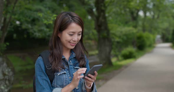 Travel woman check on smart phone at outdoor