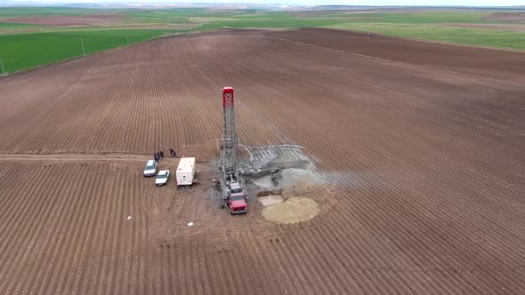 Drilling Rig Work on Flat Agricultural Brown Field