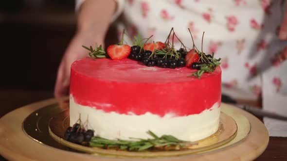 Pastry Chef Woman Is Presenting Her Layered Creamy Cake on Rotating Plate