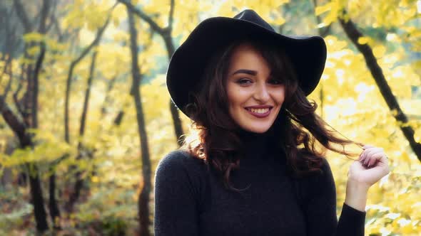 Girl walking in park. Attractive woman walking in autumn forest