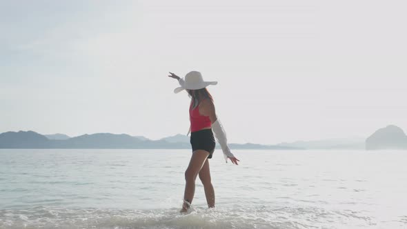 Woman Walking In Sea On Entalula Beach